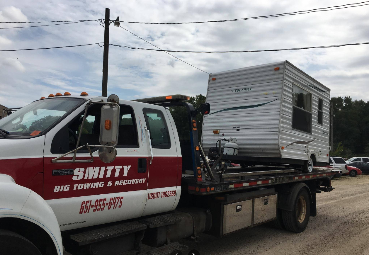 RV camper trailer secured on Smitty Big Towing flatbed